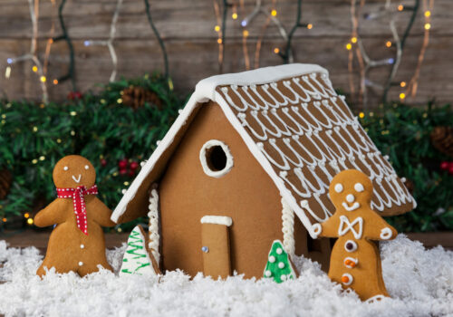 Gingerbread house and cookies arranged together Gingerbread house and cookies arranged together during christmas time